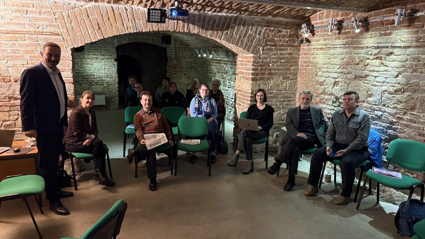 Attila Király la un workshop cu o comunitate profesională, într-o sală boltită de cărămidă din Cluj-Napoca